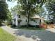 Exterior view of house with wooden deck, gravel driveway, and back entrance at 4106 N Sherman Dr, Indianapolis, IN 46226
