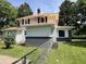 Side view of home with metal roof, showcasing a well-maintained exterior with chain-link fence at 4106 N Sherman Dr, Indianapolis, IN 46226