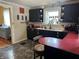 Cozy kitchen featuring black cabinets, red countertops, and a vintage-style design at 4106 N Sherman Dr, Indianapolis, IN 46226
