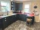 Charming kitchen with black cabinets, red countertops, and a mix of modern appliances at 4106 N Sherman Dr, Indianapolis, IN 46226