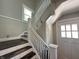 Staircase with white railing leads to upper level, natural light from window at 4106 N Sherman Dr, Indianapolis, IN 46226