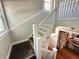 Staircase leading to upper level, with white railing and natural light from window at 4106 N Sherman Dr, Indianapolis, IN 46226