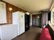 Enclosed porch with chest freezer and seating area, blending indoor and outdoor living at 4106 N Sherman Dr, Indianapolis, IN 46226