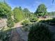 Landscaped backyard with stone paths, lush greenery, and privacy fencing, enhancing the outdoor space at 474 N Kristi Rd, Martinsville, IN 46151