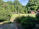 View of a well-maintained backyard with lush greenery and a charming storage shed at 474 N Kristi Rd, Martinsville, IN 46151