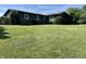 Expansive backyard with lush green grass and mature trees bordering the property, creating privacy at 474 N Kristi Rd, Martinsville, IN 46151
