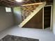 Spacious unfinished basement with exposed ceiling, brick accents, stairs, and a cozy carpet at 474 N Kristi Rd, Martinsville, IN 46151
