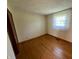 Bright bedroom with hardwood floors and neutral wall paint illuminated by natural light from a window at 474 N Kristi Rd, Martinsville, IN 46151