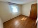 Bright bedroom with hardwood floors, natural light from a window, and simple, neutral decor at 474 N Kristi Rd, Martinsville, IN 46151