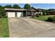 Charming home featuring a large driveway, a two-car garage and mature trees and landscaping at 474 N Kristi Rd, Martinsville, IN 46151
