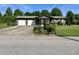 Charming home featuring a covered porch, a two-car garage and mature trees and landscaping at 474 N Kristi Rd, Martinsville, IN 46151