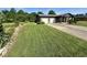 Spacious lawn with a two-car garage and beautiful landscaping, enhancing curb appeal at 474 N Kristi Rd, Martinsville, IN 46151