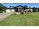 Charming single-story home with a covered porch, an American flag, and a beautifully landscaped front yard at 474 N Kristi Rd, Martinsville, IN 46151