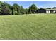 Expansive front yard with lush green grass and mature trees offering privacy and a beautiful view at 474 N Kristi Rd, Martinsville, IN 46151