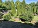 Meticulously landscaped backyard featuring lush greenery, stone pavers and decorative elements at 474 N Kristi Rd, Martinsville, IN 46151