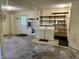 Well-lit laundry area in garage, featuring washer, dryer, shelving and easy access to outdoor door at 474 N Kristi Rd, Martinsville, IN 46151