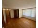 Bright living room showcasing hardwood floors and natural light from large windows with lace curtains at 474 N Kristi Rd, Martinsville, IN 46151