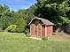 Quaint red storage shed with green trim and a star accent nestled in a lush green lawn at 474 N Kristi Rd, Martinsville, IN 46151