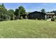 Lush side yard with mature trees, offering a tranquil and private outdoor space at 474 N Kristi Rd, Martinsville, IN 46151