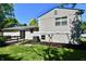 Rear view of a home featuring a deck, sliding glass door, and manicured garden at 524 Concord Ct, Fishers, IN 46038