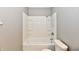 A bright bathroom with a white tub and tiled shower surround, offering a clean design at 524 Concord Ct, Fishers, IN 46038