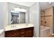 Bathroom featuring double sinks, and a tiled shower-tub combination, creating an oasis at 524 Concord Ct, Fishers, IN 46038