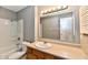 Well-lit bathroom features a single sink vanity and tiled shower-tub combination at 524 Concord Ct, Fishers, IN 46038
