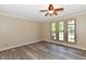 Cozy bedroom with ample natural light, ceiling fan, and modern flooring at 524 Concord Ct, Fishers, IN 46038