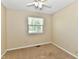 Bright bedroom with beige carpet, natural light from the window and a ceiling fan at 524 Concord Ct, Fishers, IN 46038