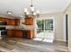 Open kitchen area with modern appliances, wood cabinets, a chandelier, and sliding glass door at 524 Concord Ct, Fishers, IN 46038