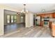 Open-concept kitchen featuring stainless steel appliances, wood cabinets, and modern gray floors at 524 Concord Ct, Fishers, IN 46038