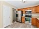 Well-equipped kitchen with stainless steel appliances, wooden cabinets, and door at 524 Concord Ct, Fishers, IN 46038