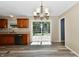 Bright kitchen area with cabinets, lighting, sliding glass doors, and a modern dishwasher at 524 Concord Ct, Fishers, IN 46038