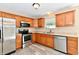 Bright kitchen featuring stainless steel appliances, wood cabinetry, and a sink under a window at 524 Concord Ct, Fishers, IN 46038