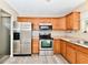 Well-equipped kitchen with stainless steel appliances, wooden cabinets, and ample countertop space at 524 Concord Ct, Fishers, IN 46038