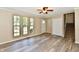 Bright living room with large windows, ceiling fan, and modern flooring at 524 Concord Ct, Fishers, IN 46038