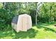 Well-maintained shed in a lush backyard setting with mature trees and landscaping at 524 Concord Ct, Fishers, IN 46038