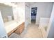 Bright bathroom with a clean sink, white tiled floor, and access to a closet for ample storage at 5652 Apple Branch Way, Indianapolis, IN 46237