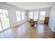 Dining room with wood-look floors, large windows and sliding glass doors at 5652 Apple Branch Way, Indianapolis, IN 46237