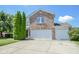 Well-maintained home with a brick facade, double garage, and mature landscaping offers great curb appeal at 5652 Apple Branch Way, Indianapolis, IN 46237