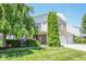 Charming two-story home boasts a well-manicured lawn and inviting curb appeal at 5652 Apple Branch Way, Indianapolis, IN 46237