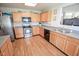 The kitchen features stainless steel appliances, wooden cabinets, and gray counter tops at 5652 Apple Branch Way, Indianapolis, IN 46237