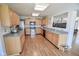 The kitchen features wooden cabinets, stainless steel appliances, and vinyl floors at 5652 Apple Branch Way, Indianapolis, IN 46237
