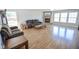 Open living room boasts hardwood floors, stone fireplace, and large windows at 5652 Apple Branch Way, Indianapolis, IN 46237