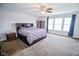 Spacious bedroom with a large bed, soft carpet, and bright natural light from a large window at 5652 Apple Branch Way, Indianapolis, IN 46237
