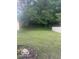 View of spacious backyard lawn, shed, and wood fence at 6548 Frankenberger Dr, Indianapolis, IN 46237