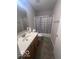 Modest bathroom with tile floor, shower-tub and wooden vanity at 6548 Frankenberger Dr, Indianapolis, IN 46237