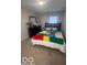 Bedroom featuring a colorful bedspread and neutral carpet at 6548 Frankenberger Dr, Indianapolis, IN 46237