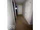 A carpeted hallway with white doors and light gray walls at 6548 Frankenberger Dr, Indianapolis, IN 46237
