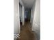 View of a narrow hallway with carpet flooring, and closed doors at 6548 Frankenberger Dr, Indianapolis, IN 46237